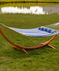 Curved Wood Hammock Stand For Outdoor Use Fits Most 9 To 12 Foot Hammocks 13 Foot Overall Length 400 Pound Capacity Built To Last Two Person Frame In Weather Ready Larch Wood in a grassy yard.