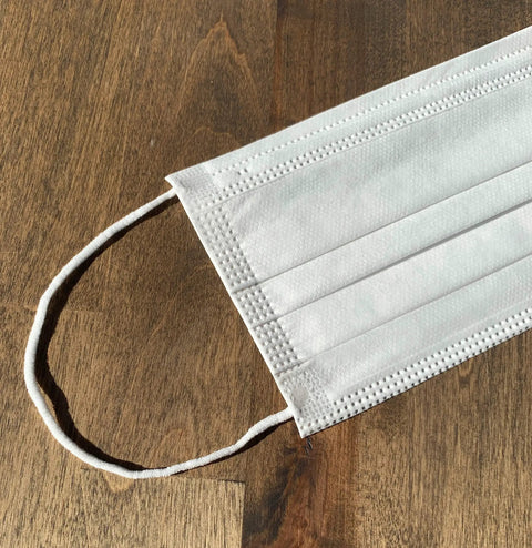 Made In USA 3 Layer Disposable Face Masks Bulk Pack 500 Count with ear loop on wooden surface
