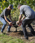 Two people operating Earth Auger Combo With 52cc Two Cycle Powerhead And 8 Inch Auger Included Heavy Duty Handlebars, Model 58630