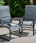 Set Of Two Padded Textilene Patio Dining Chairs With C Spring Rocker Action And Curved Armrests Rock Solid Powder Coated Metal Frame Prime Poolside Garden Furniture Built Tough For Weekend Hangouts In Blue And Black - side view in outdoor setting