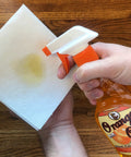 Keep Your Wood Looking Crisp And Protected With This Real Orange Oil Polish That Hits Different On Tables And Cabinets Delivering A Smooth Dime Shine While Blocking Daily Wear And Tear For Sure, spray bottle with orange oil polish on paper towel.