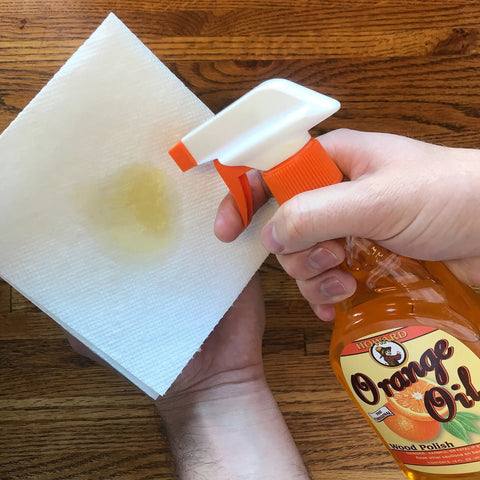 Keep Your Wood Looking Crisp And Protected With This Real Orange Oil Polish That Hits Different On Tables And Cabinets Delivering A Smooth Dime Shine While Blocking Daily Wear And Tear For Sure, spray bottle with orange oil polish on paper towel.