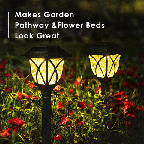 6 Pack Solar Pathway Lights Outdoor LED Garden Lights illuminating flower bed at night with warm glow
