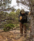 Man using Gator Machete 25 Inch Two In One Machete With 18 Inch Plain Edge Blade And Reverse Saw Textured Gator Grip Handle on a tree.