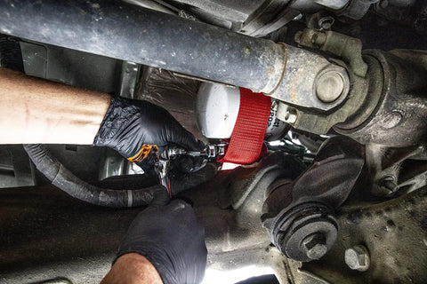 Mechanic using Heavy Duty Oil Filter Strap Wrench With Three Eighths And One Half Inch Drive Nylon Strap Forged Steel Handle