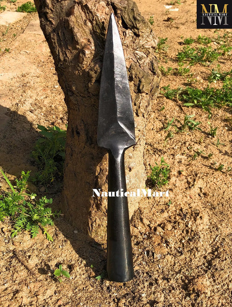Hand Forged Viking Saga Iron Spear Point For Reenactment And LARP Carbon Steel Long Spearhead against a tree trunk.