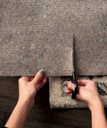 Person cutting Non Slip Rug Pad Basic Grey Cushioned Underlay Keeps Rugs From Slipping, Wrinkling, And Floor Scratches, Cut To Fit