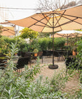 Heavy Duty 35 Lbs Bronze Umbrella Base With Adjustable Pole Holder in garden patio setting