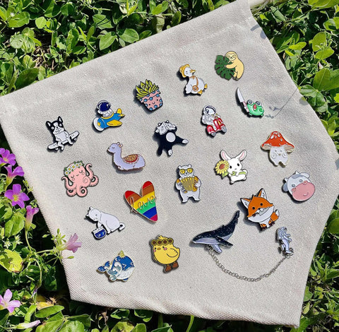Dope And Super Cute Enamel Backpack Pins Bulk Set Loaded With Funny Anime Series Designs For Slaying Your Daily Outfit Premium Zinc Alloy Clasp For Backpacks Jackets And Helmets in colorful assortment on fabric.