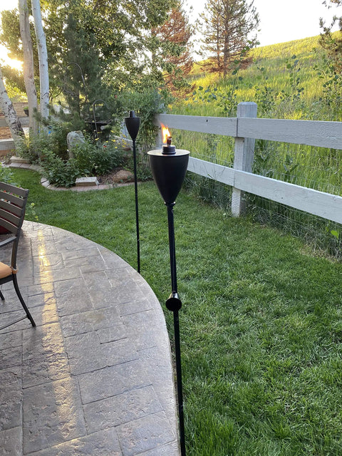 Conical Bronze Outdoor Torch Set For Backyards And Patios, Weather Resistant And Citronella Oil Compatible, installed in garden