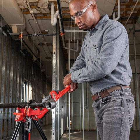 Person using Heavy Duty 14 Inch Straight Pipe Wrench With Forged Alloy Jaws For Fast Gripping And Quick Ratcheting Action 2 Inch Pipe Capacity
