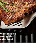Three Piece Grilling Tool Set With Stainless Steel Turner lifting steak on grill