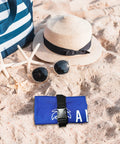 Beach umbrella sand anchor bag windproof weight for heavy wind folded on sand near sun hat and sunglasses