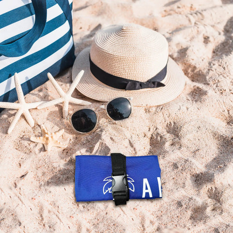 Beach umbrella sand anchor bag windproof weight for heavy wind folded on sand near sun hat and sunglasses