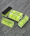 Magnetic Small Bubble Levels, multifunctional folding spirit level, lightweight, compact, four bright vials on a fabric backdrop.