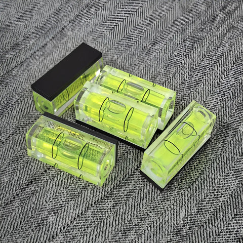 Magnetic Small Bubble Levels, multifunctional folding spirit level, lightweight, compact, four bright vials on a fabric backdrop.