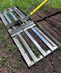 Lawn Leveling Rake Stainless Steel Ground Plate 30 By 10 Inches With 78 Inch Extra Long Handle on grassy and soil surface