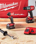 Heavy Duty Cordless Hammer Drill And Impact Driver Combo Kit Built Tough For Ripping Through Concrete Masonry And Metal on wood surface with charger