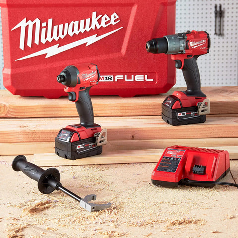 Heavy Duty Cordless Hammer Drill And Impact Driver Combo Kit Built Tough For Ripping Through Concrete Masonry And Metal on wood surface with charger