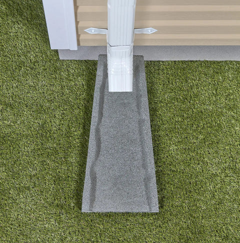 Heavy Duty Two Pack Premium Rubber Downspout Splash Blocks Built Damn Tough With A Slick Stone Texture For Top Shelf Yard Drainage And Clean Rainwater Management In Gray positioned under gutter outlet on grass.