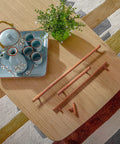 Overhead view of Six Pack 3 Inch Hole Center Antique Copper Zinc Alloy Cabinet Pulls displayed on a wooden surface with tea set.