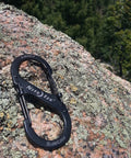Dual S Biner Slide Lock Carabiner With Black Stainless Steel Finish Locking Two Gate Clip on rock surface