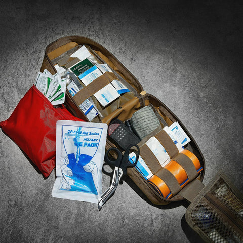 CareTac IFAK trauma kit, open brown tactical pouch with CAT Gen 7 tourniquet, Israeli bandage, chest seals and supplies
