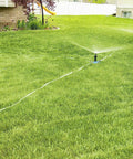 Effortless Above Ground All In One Sprinkler System For Lawn Kit portable yard watering solution with three spray bases in lawn.