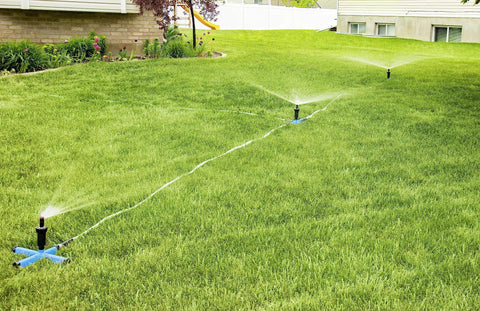 Effortless Above Ground All In One Sprinkler System For Lawn Kit portable yard watering solution with three spray bases in lawn.