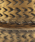 Close-up of texture on Caine Aluminum Planters In Aged Brass For Indoor Plants, handcrafted with vintage vibe zigzag pattern.