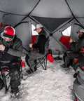 Three anglers inside Heavy Duty Pop Up Insulated Ice Fishing Shelter With Knockout Spacious Fishin Spot For Five To Seven Crews Quick Roll Setup Trip Proof Door Wide Flared Bottom Red Black 94 Square Feet.