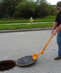 Kickass Three Magnet Manhole Lid Lifter Pulls Up To Two Hundred Fifty Pounds No Sweat featuring ergonomic handles lifting a manhole cover.