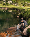 Man using Replacement 6.0 Liter Water Reservoir Kit For GravityWorks System by a scenic riverside