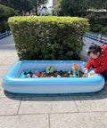 Inflatable Kids Pool With Air Pump For Toddlers, Large Sensory Sand And Water Play Pit, Outdoor Backyard Wading Pool with child playing