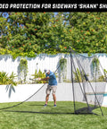 Man practicing golf with Shank Net Attachment For Golf Hitting Nets Catches Errant Shots Left Or Right Handed And Fits 10x7 And 7x7 Foot Nets Attaches Securely To Stop Shanks And Hosels In Backyard Practice Black in backyard.