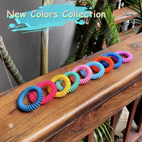 Colorful 18 Pack Mosquito Repellent Bracelets With 60 Patch Refills displayed on wooden rail, DEET-Free for outdoor use