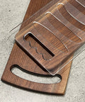 Six In One Charcuterie Board Handle Template Acrylic Router Guide For Carving Out Smooth Corner Grips On Cutting Boards And Serving Trays. Clear acrylic template on wooden cutting board.