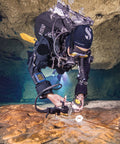 Diver using Wrist Dive Computer With Bungee Straps for deep sea adventures in underwater cave.