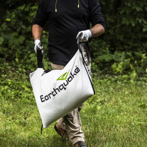 Person carrying a dock and lock debris bag for Heavy Duty 301cc Chipper Shredder With 4 Cycle Viper Engine.