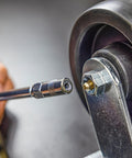 Close-up of Heavy Duty Mini Grease Gun Kit With Pistol Grip, 4500 PSI, 3oz Cartridges, Zerk Fitting on a wheel bearing.