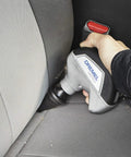 Cordless Power Scrubber Auto Detailing Kit With Four Cleaning Pads, Bristle Brush, shown cleaning car seat crevice.