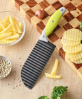 Angled view of VRUIFA French fry crinkle cutter with lime-green non-slip handle and ribbed black blade