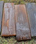 Wet wooden plank-style pavers on grass created with Two Piece Concrete Mold Set With Realistic Old Wood Look For Garden Stepping Stones Patio Pavers And Walkways Wood Grain Cement Molds To Create Weathered Plank Style Outdoor Tiles For Paths And Patios