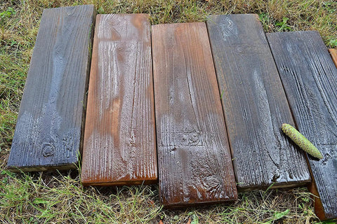 Wet wooden plank-style pavers on grass created with Two Piece Concrete Mold Set With Realistic Old Wood Look For Garden Stepping Stones Patio Pavers And Walkways Wood Grain Cement Molds To Create Weathered Plank Style Outdoor Tiles For Paths And Patios