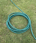 Heavy Duty Flexogen Three Quarters Inch By Fifty Foot Garden Hose With Eight Layer Construction And Five Hundred Psi Burst Strength coiled on grass