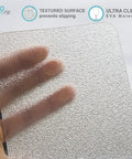 Close-up of clear non-slip tape 4 inch by 30 feet, textured surface, showing grippy adhesive for tubs, boats, stairs.