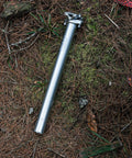 Crossfire Bike Seat Post 350mm Length, 27.2mm Diameter, AL6061 Aluminum, 3D Forged, Blast Silver Finish on forest floor