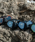 Four Raptor Low Volume Freediving And Spearfishing Masks With Silicone Skirt Overmolded On The Frame On Rocky Surface