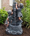Outdoor Water Fountain With Boy And Girl Statues, Antique Bronze Finish, 32.2x18.2x17.6 in, displayed in garden setting