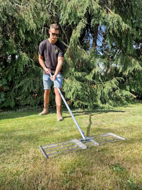 Person using 38 Inch Wide Leveling Lawn Rake With Stainless Steel Head And 72 Inch Aluminum Handle Top Notch Heavy Duty Yard Leveler